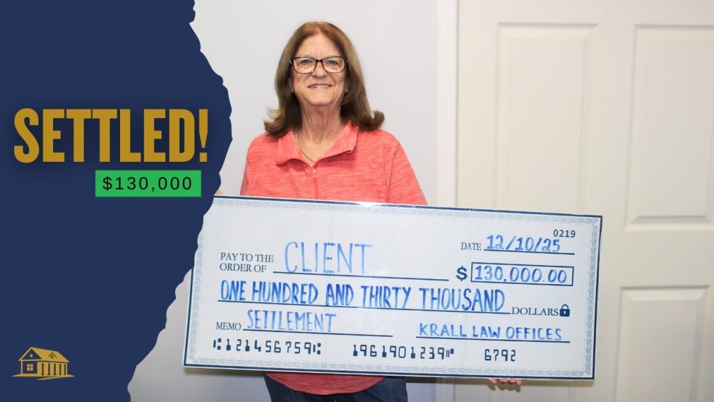 Client holding a settlement check for $130,000