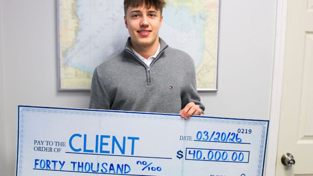 Client holding a check for forty thousand dollars
